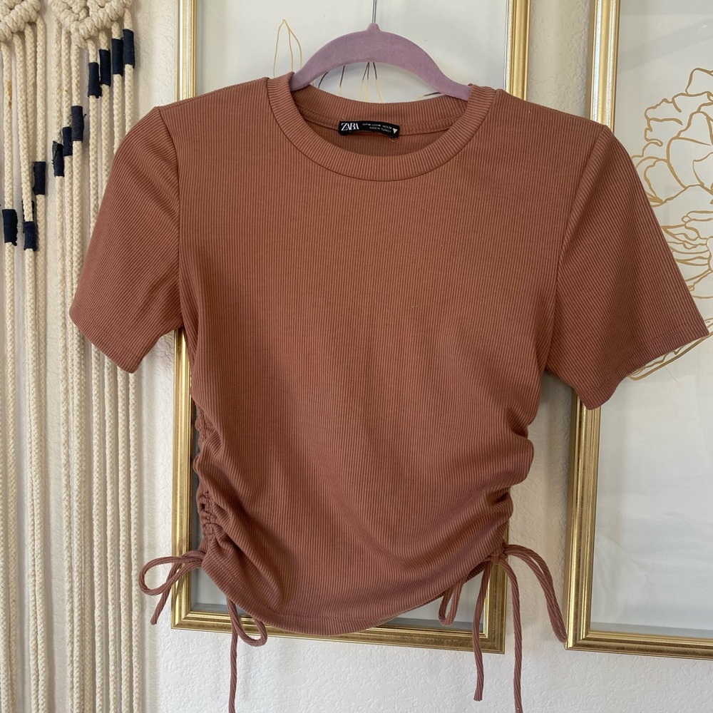 Worn a few times, can scrunch the sides to make it more or less cropped